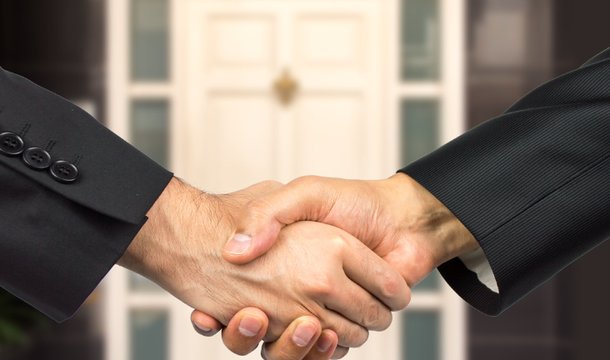 a picture of two estate agent's shaking hands