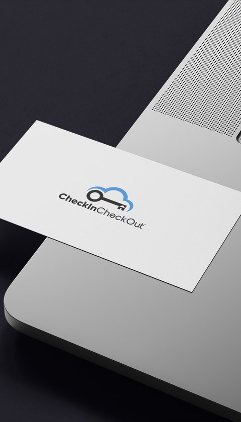 a checkincheckout business card placed on a laptop